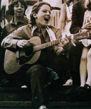 Susan Klock
        Kairalla playing her guitar